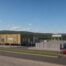 Architectural visualisation of MorGen Energy’s proposed West Wales Hydrogen facility in Milford Haven, showing industrial buildings, hydrogen production infrastructure and associated equipment.