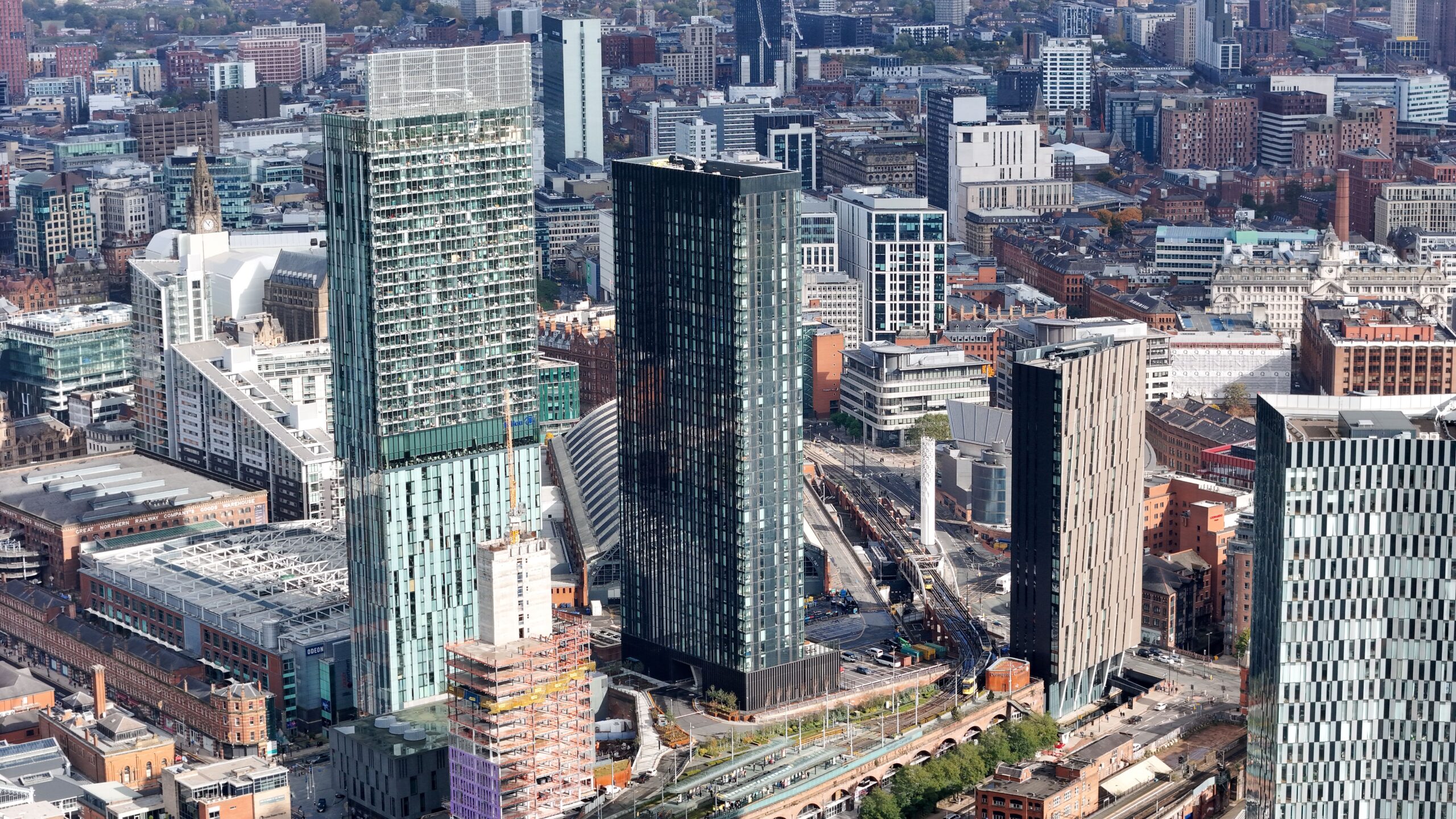 pexels-mylokaye-29005978 Aerial view of Manchester city centre, showing high-rise commercial buildings, construction developments and railway infrastructure around Manchester Piccadilly station.